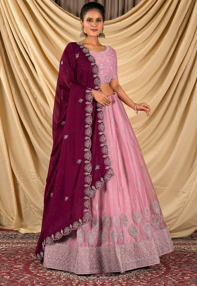 Woman wearing a pink lehenga with matching blouse