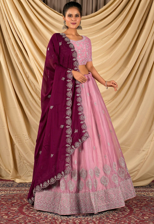 Woman wearing a pink lehenga with matching blouse