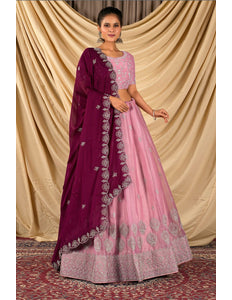 Woman wearing a pink lehenga with matching blouse