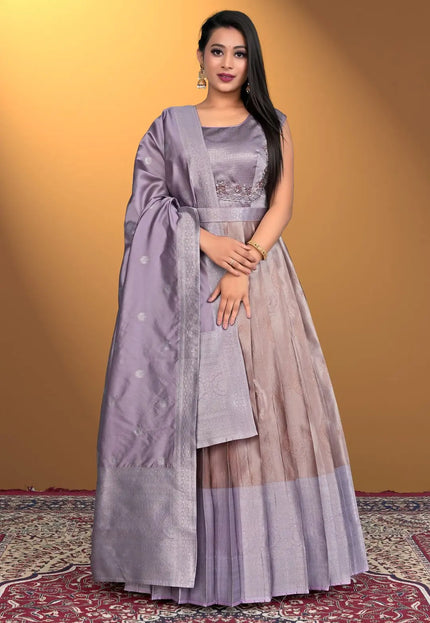 Woman wearing a traditional outfit with a purple and beige dress