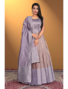 Woman wearing a traditional outfit with a purple and beige dress