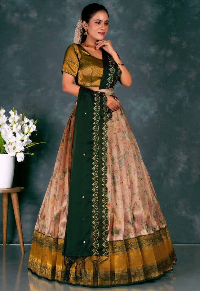 Woman wearing a traditional green and pink lehenga choli with dupatta