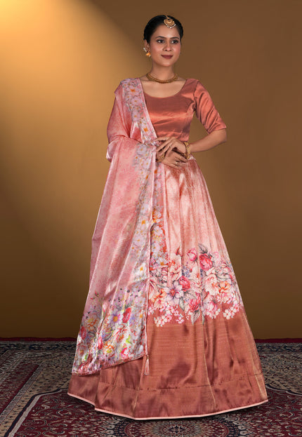 Woman wearing a traditional pink lehenga choli with floral patterns