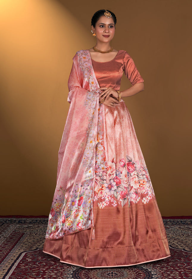 Woman wearing a traditional pink lehenga choli with floral patterns
