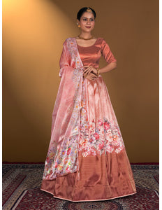 Woman wearing a traditional pink lehenga choli with floral patterns
