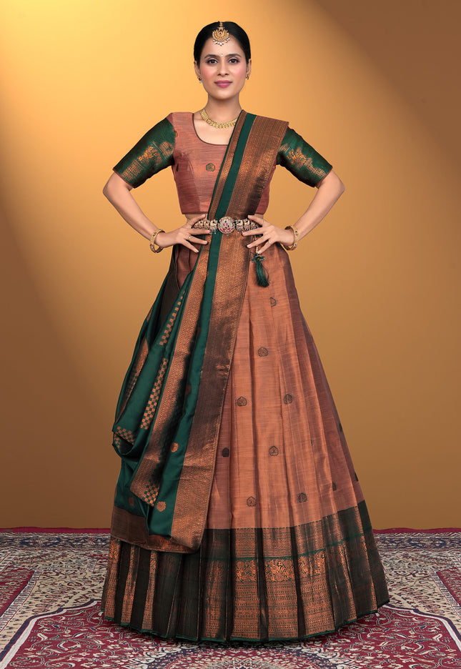 Woman wearing a traditional brown and peach pink lehenga with blouse