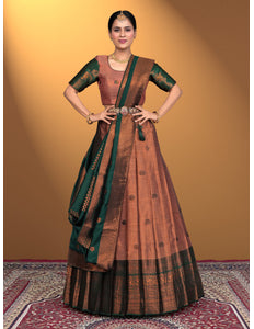 Woman wearing a traditional brown and peach pink lehenga with blouse
