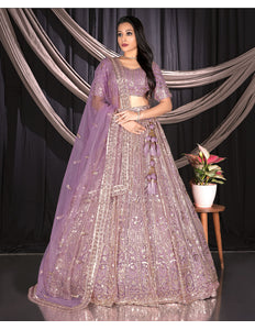 Woman in a purple embroidered traditional chaniya choli