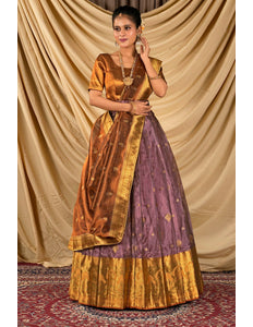 Woman wearing a traditional outfit with a gold and purple lehenga choli with dupatta
