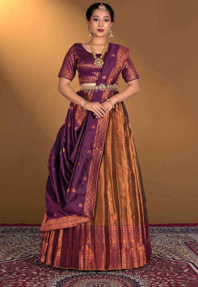 Woman wearing a traditional purple and orange lehenga choli