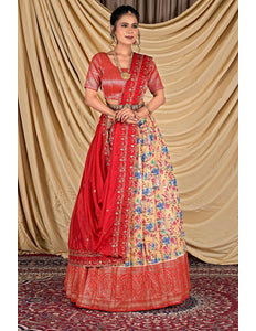 Woman wearing a traditional red and floral lehenga choli with dupatta