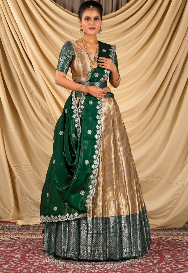 Woman wearing a green and peach lehenga choli with dupatta