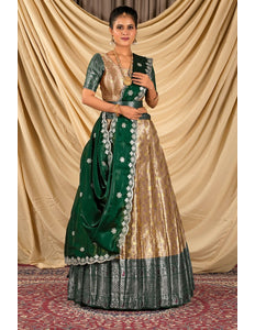 Woman wearing a green and peach lehenga choli with dupatta