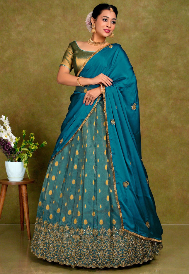 Woman wearing a traditional Peacock lehenga with gold patterns