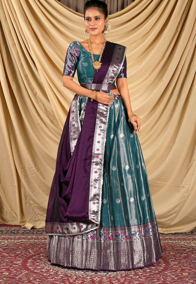 Woman wearing a traditional outfit with a purple and peacock lehenga choli with dupatta