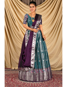 Woman wearing a traditional outfit with a purple and peacock lehenga choli with dupatta