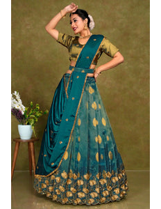 Woman in a traditional green and blue outfit with floral patterns