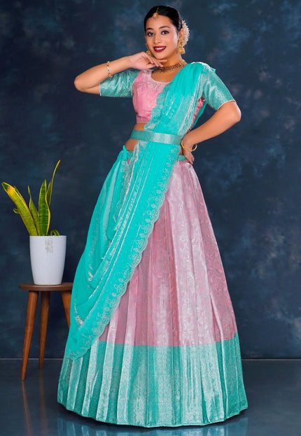Woman in a teal and pink traditional lehenga choli with dupatta
