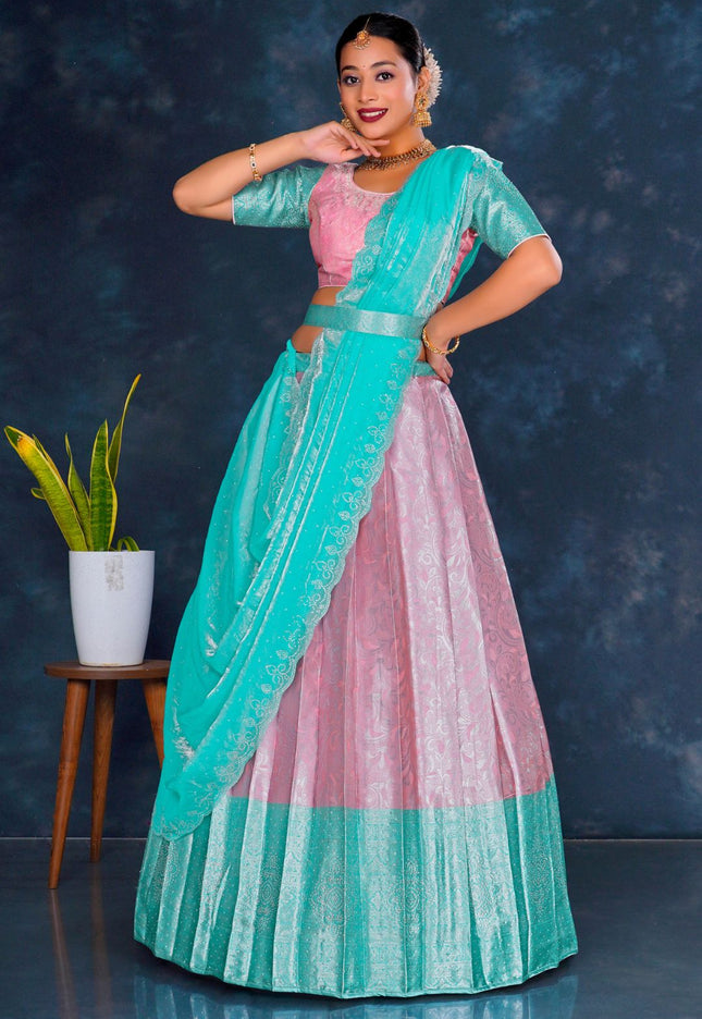 Woman in a teal and pink traditional lehenga choli with dupatta