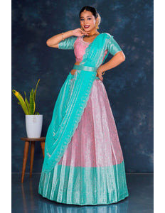 Woman in a teal and pink traditional lehenga choli with dupatta