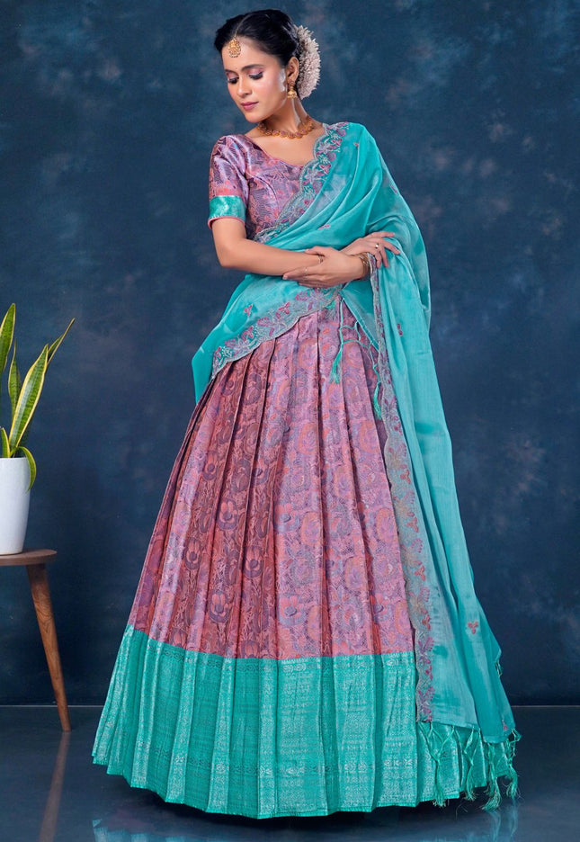 Woman wearing a traditional outfit with a pink and sea green lehenga choli with dupatta