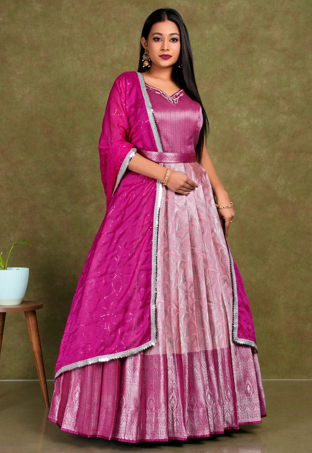 Woman wearing a pink traditional outfit with a matching dupatta