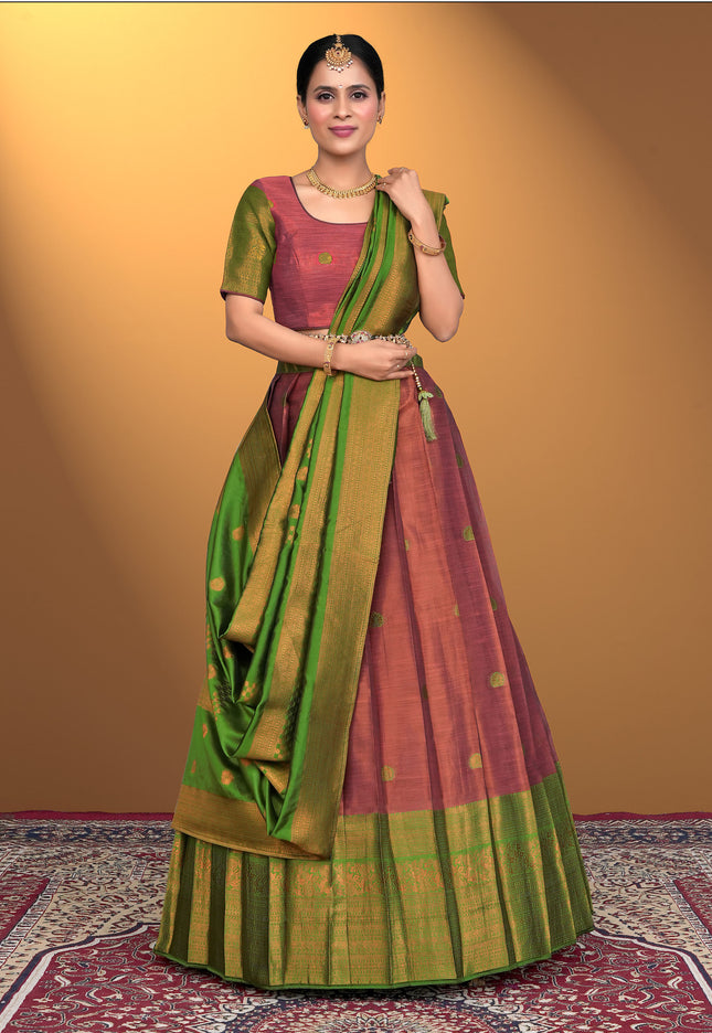 Woman wearing a traditional pink lehenga choli with green dupatta