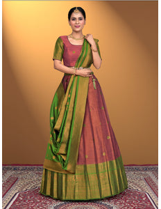 Woman wearing a traditional pink lehenga choli with green dupatta