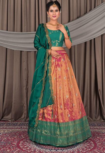 Woman wearing a traditional green and pink lehenga with a matching dupatta