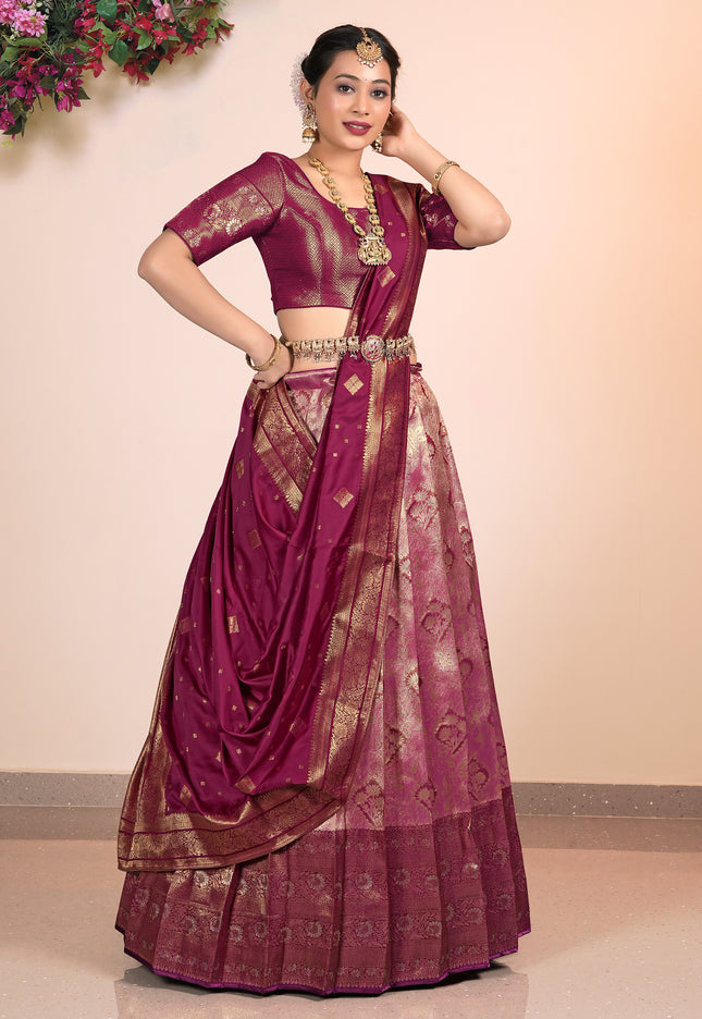 Woman wearing a traditional Pink Half-Saree with gold patterns