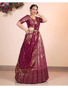 Woman wearing a traditional Pink Half-Saree with gold patterns