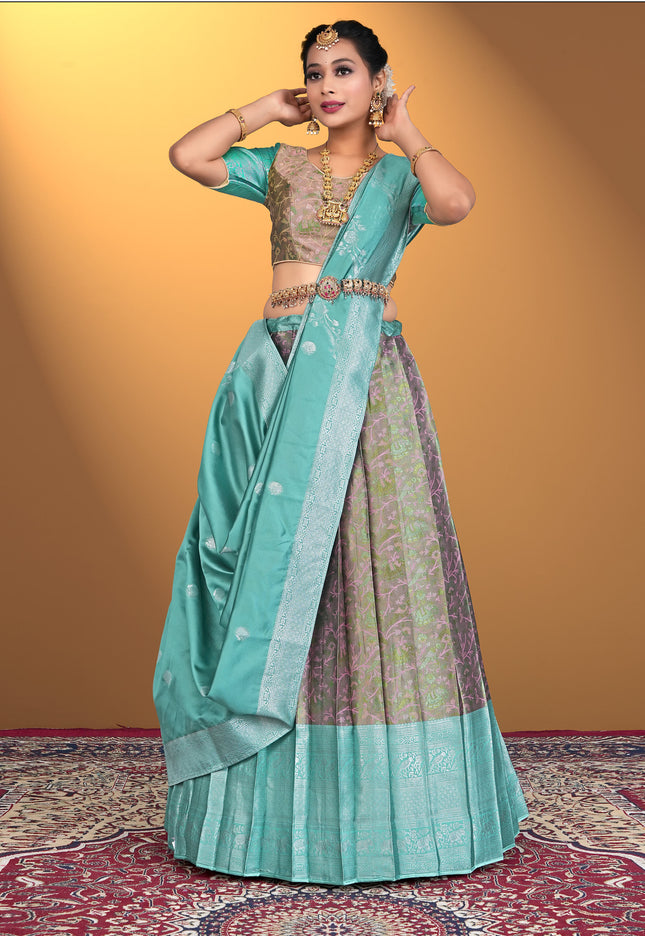 Woman wearing a traditional outfit with a teal lehenga choli