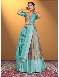 Woman wearing a traditional outfit with a teal lehenga choli