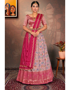 Woman in a traditional pink and multicolored lehenga choli with dupatta