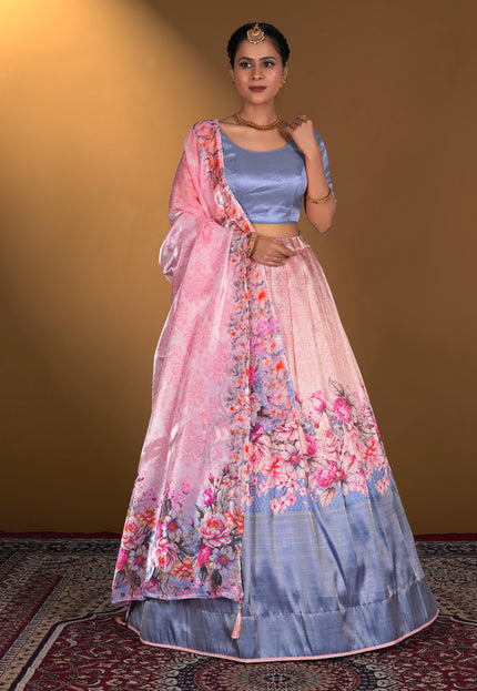 Woman wearing a pink and blue floral lehenga with a matching blouse