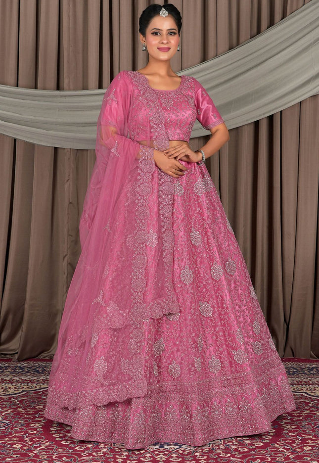 Woman wearing a pink traditional outfit with intricate designs