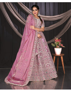 Woman in a pink embroidered traditional Lehenga Choli