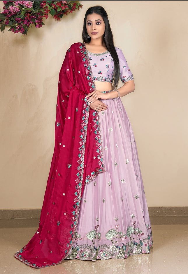 Woman wearing a pink lehenga with a matching blouse