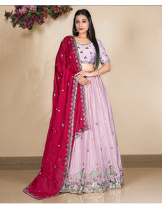 Woman wearing a pink lehenga with a matching blouse