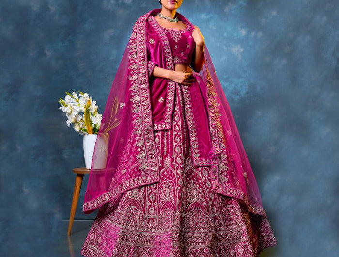 Woman in a traditional pink embroidered lehenga choli with dupatta