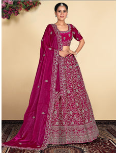Woman wearing a traditional pink embroidered lehenga with a matching blouse