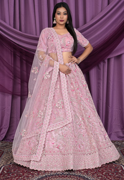 Woman wearing a pink embroidered lehenga choli