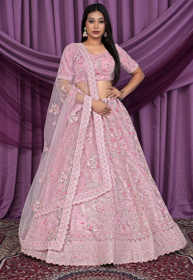 Woman wearing a pink embroidered lehenga choli