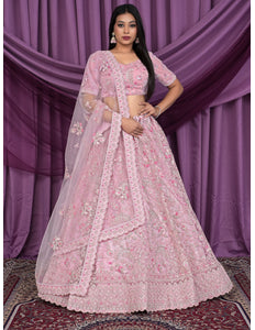 Woman wearing a pink embroidered lehenga choli