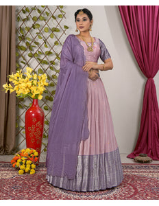 Woman in a traditional outfit with a purple and pink lehenga choli with dupatta