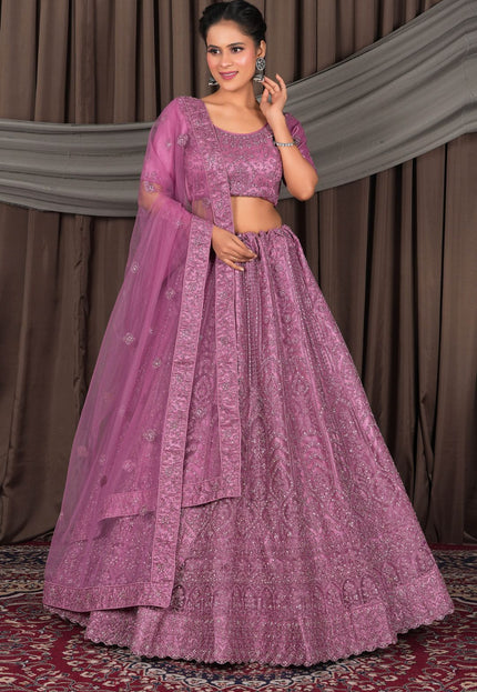 Woman wearing a traditional pink outfit with a matching dupatta