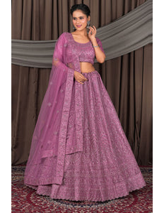 Woman wearing a traditional pink outfit with a matching dupatta