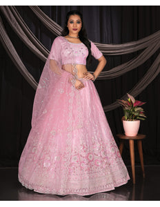 Woman wearing a pink embroidered lehenga