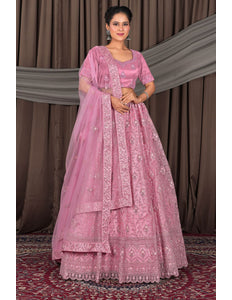 Woman wearing a pink traditional outfit with a matching dupatta