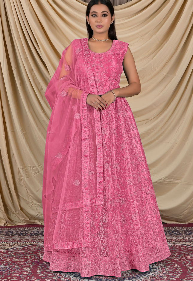 Woman wearing a pink traditional outfit with a matching dupatta